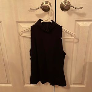 Womens black sleeveless formal top with collar.